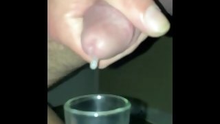 Drops of cum keep falling as I milk my cock into a glass- slo-mo