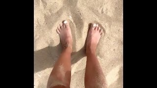 Feet playing in the sand