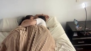 Lesbian sex under the covers on a cold morning