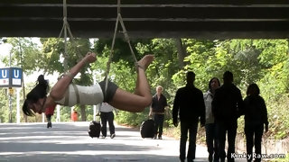 Naughty suspended from a bridge in public