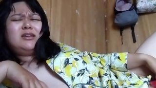 A perverted Japanese woman writhes in agony while masturbating with a toy.