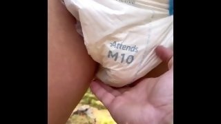 Diapered girl peeing in diapers
